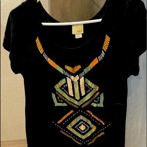 A black t shirt with beautiful silver and gold details.